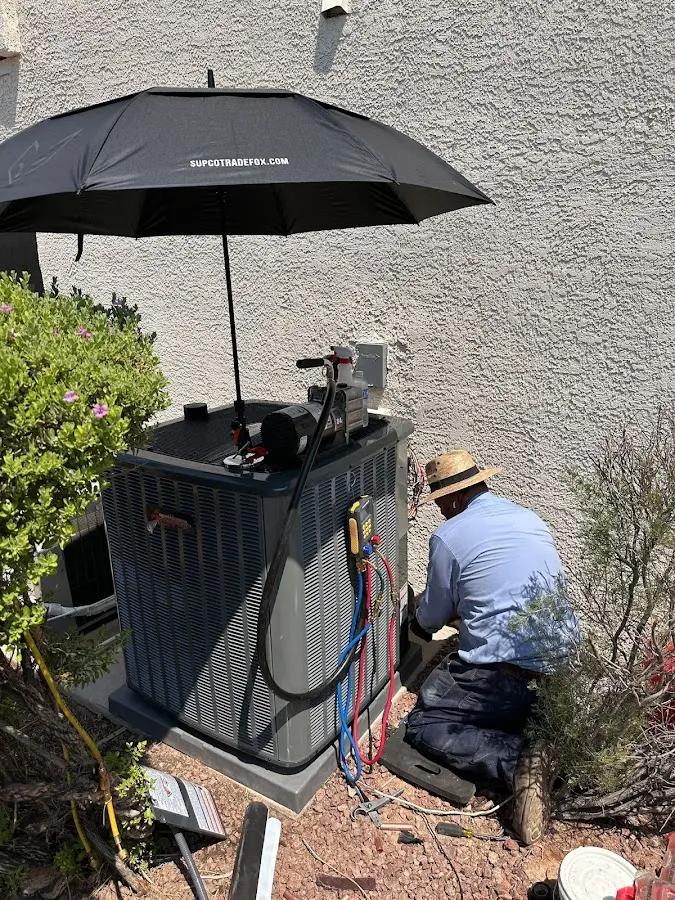 HVAC technician performing outdoor AC maintenance in Elizabeth