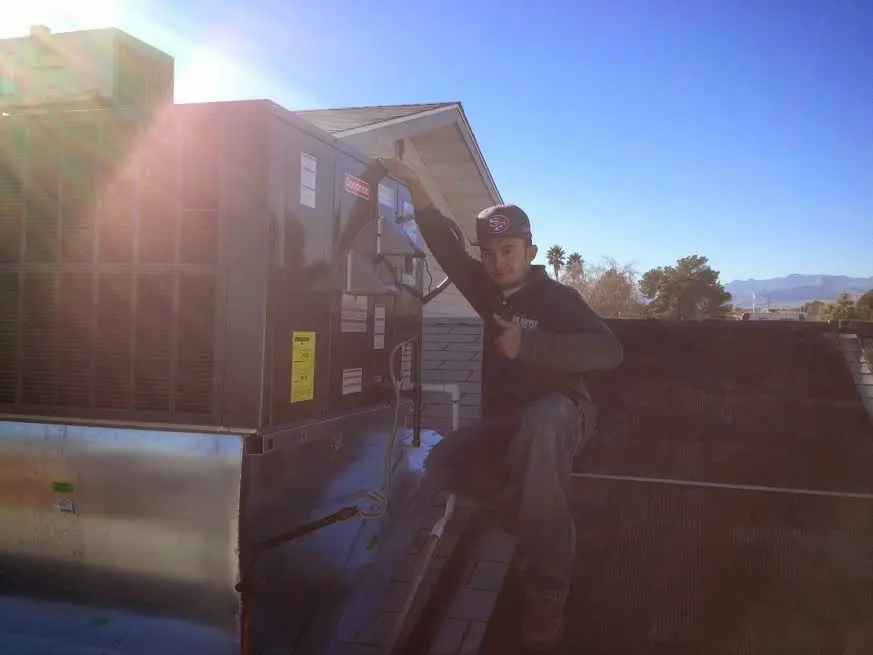 HVAC technician performing HVAC Inspection on a rooftop unit in Elizabeth